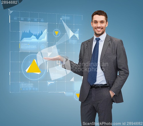 Image of businessman showing graph on virtual screen