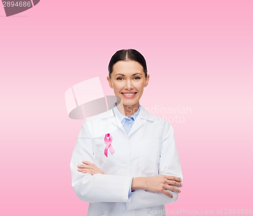 Image of smiling female doctor with cancer awareness ribbon