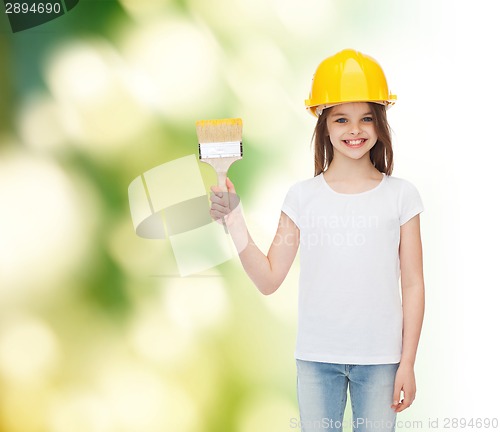 Image of smiling little girl in helmet with paint brush