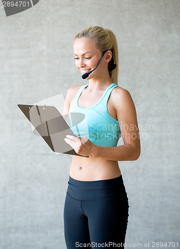 Image of beautiful athletic woman in gym