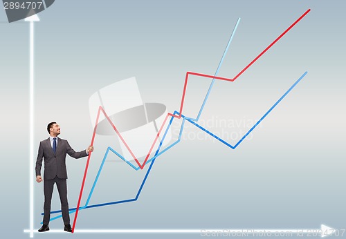 Image of smiling man holding graph line