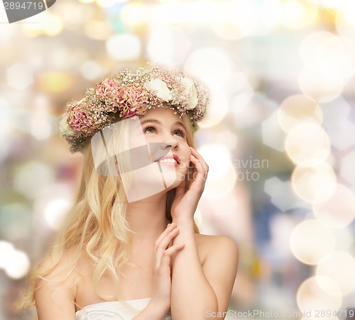 Image of young woman wearing wreath of flowers