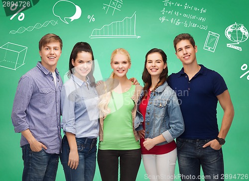 Image of group of smiling students over green board