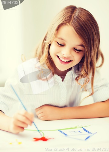 Image of little girl painting at school
