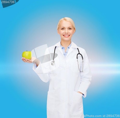 Image of smiling female doctor with green apple