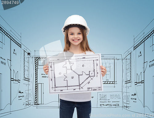 Image of smiling little girl in helmet showing blueprint