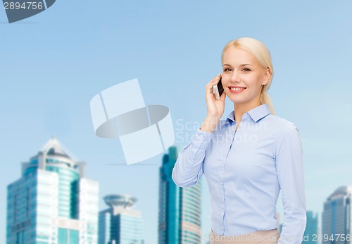 Image of young smiling businesswoman with smartphone