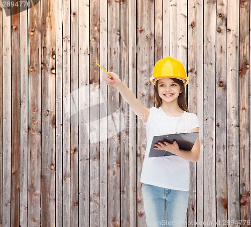 Image of smiling little girl in hardhat with clipboard