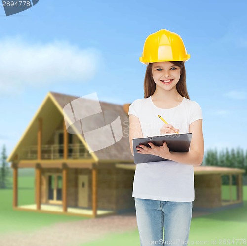 Image of smiling little girl in hardhat with clipboard