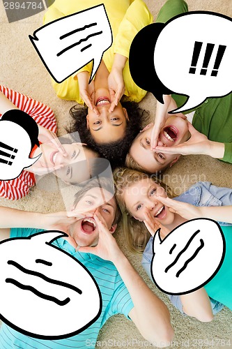 Image of smiling people lying down on floor and screaming