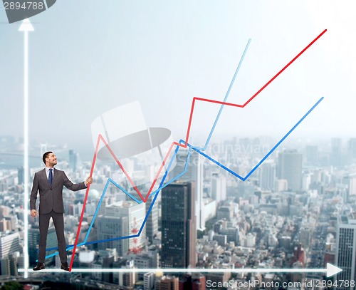 Image of smiling man holding graph line