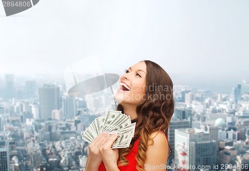 Image of woman in red dress with us dollar money