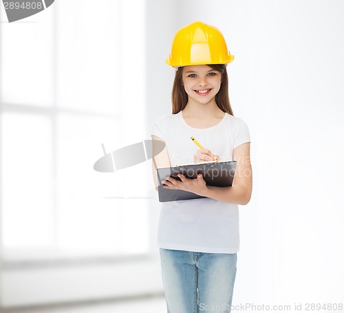 Image of smiling little girl in hardhat with clipboard