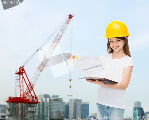 Image of smiling little girl in hardhat with clipboard