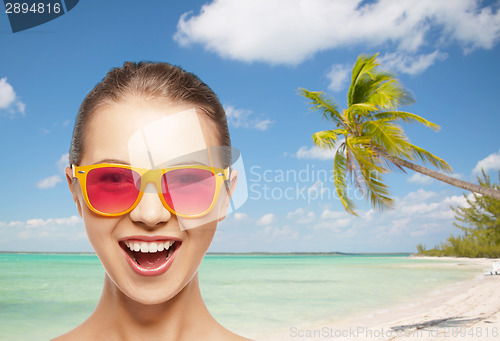 Image of happy teenage girl in pink sunglasses