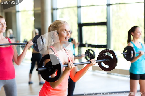 Image of group of women with barbells in gym