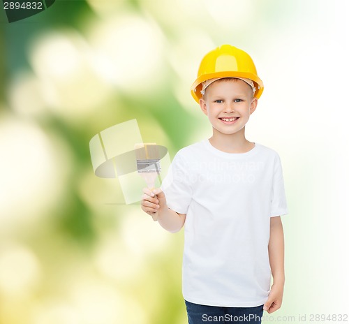 Image of smiling little boy in helmet with paint brush