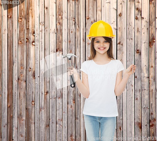 Image of smiling little girl in hardhat with hammer