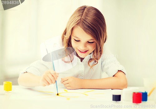 Image of little girl painting at school