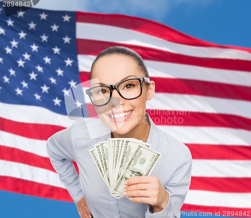 Image of smiling businesswoman with dollar cash money