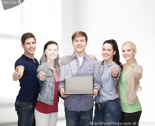 Image of smiling students with laptop computer