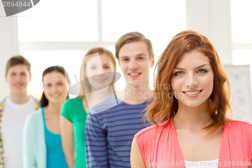 Image of smiling students with teenage girl in front