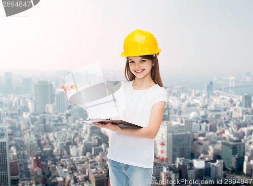 Image of smiling little girl in hardhat with clipboard