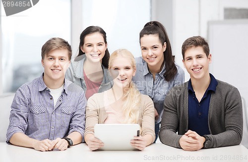 Image of smiling students with tablet pc at school