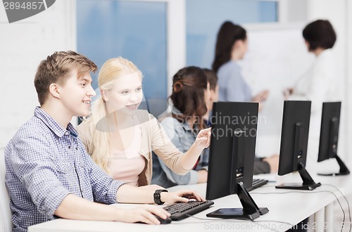 Image of students with computer monitor at school