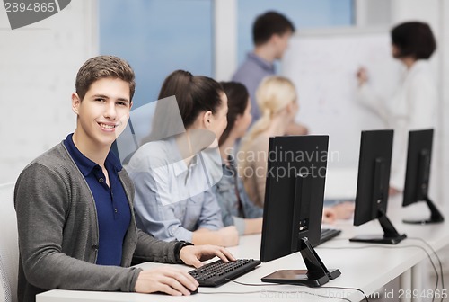 Image of students with computer monitor at school