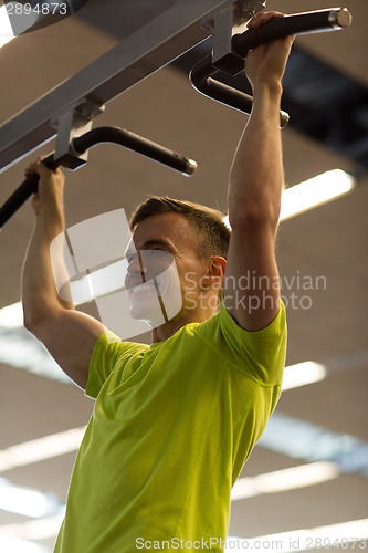 Image of smiling man exercising in gym