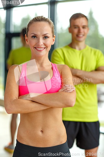 Image of smiling man and woman in gym