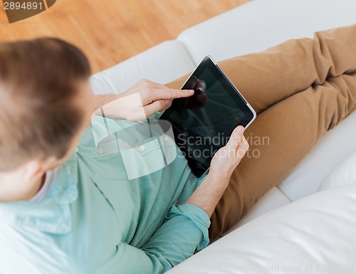 Image of close up of man with tablet pc computer at home