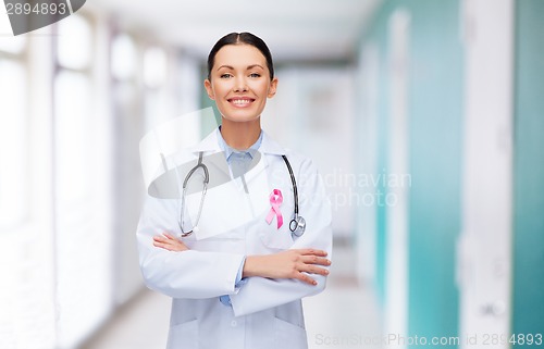 Image of doctor with stethoscope, cancer awareness ribbon