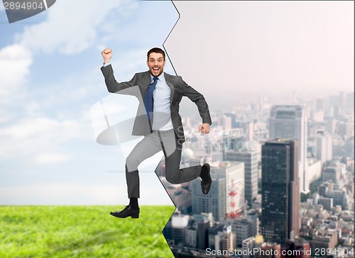 Image of smiling happy businessman jumping