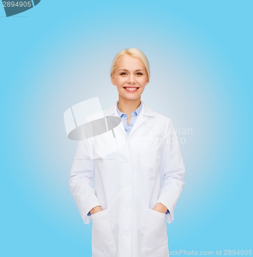 Image of smiling female doctor over blue background