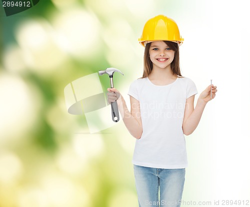 Image of smiling little girl in hardhat with hammer