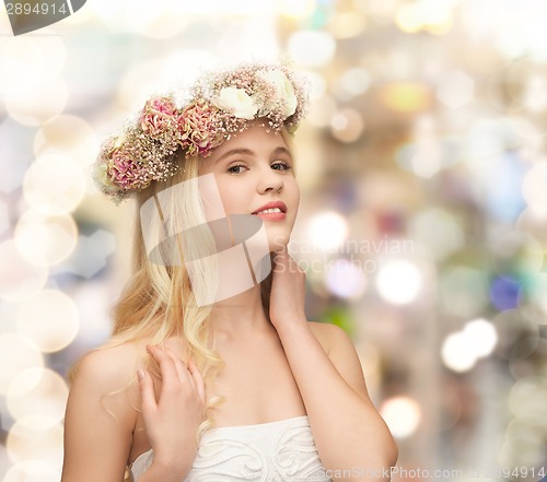 Image of young woman wearing wreath of flowers