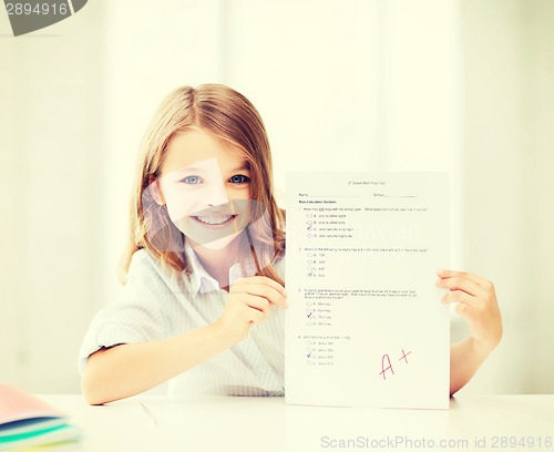 Image of girl with test and A grade at school