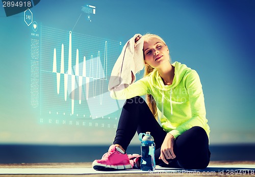 Image of woman resting after doing sports outdoors