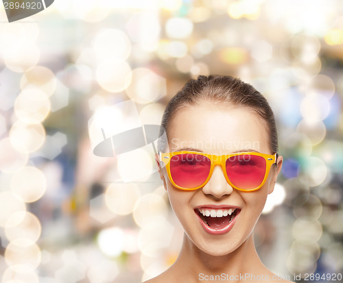 Image of happy teenage girl in pink sunglasses