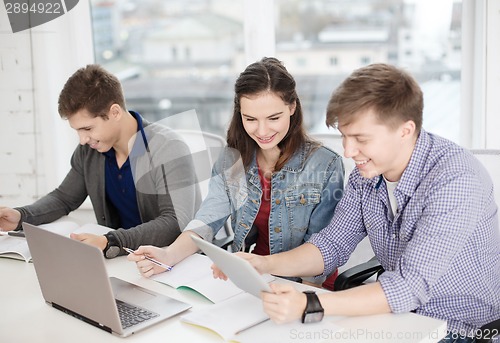 Image of students with laptop, notebooks and tablet pc