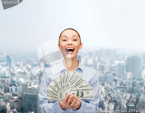 Image of laughing businesswoman with dollar cash money