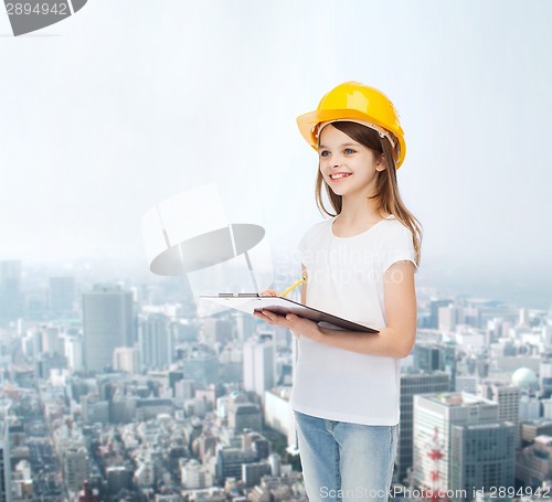 Image of smiling little girl in hardhat with clipboard