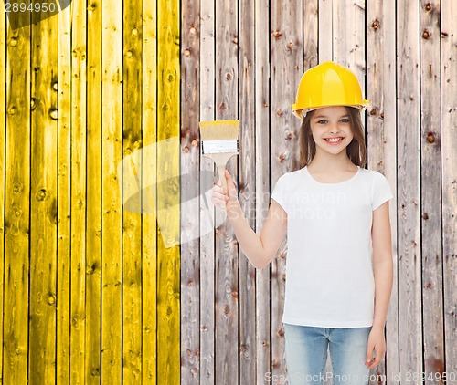 Image of smiling little girl in helmet with paint brush