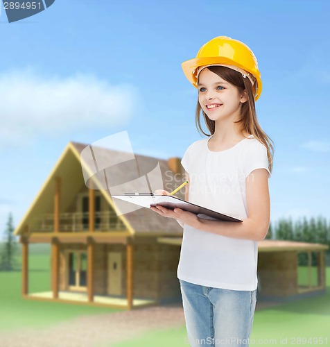 Image of smiling little girl in hardhat with clipboard