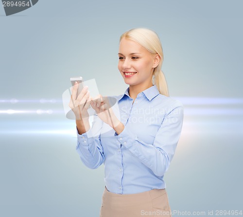 Image of young smiling businesswoman with smartphone