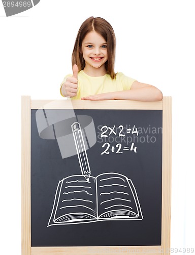 Image of smiling girl with blackboard showing thumbs up