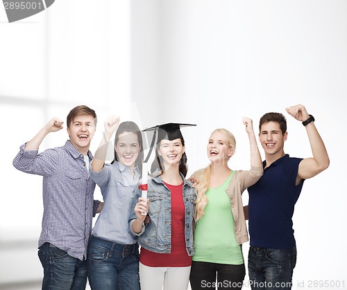 Image of group of standing smiling students with diploma