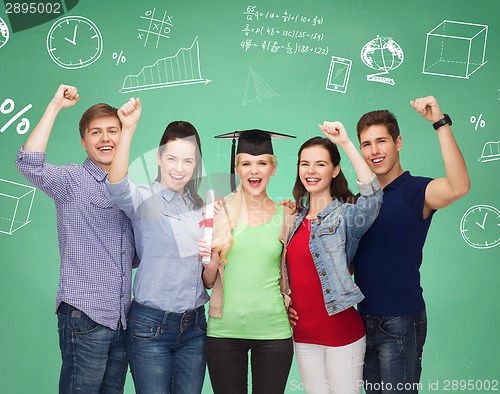 Image of group of smiling students over green board